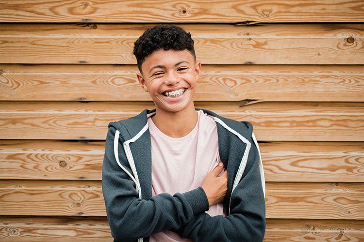 Young Teenage boy with braces smiling