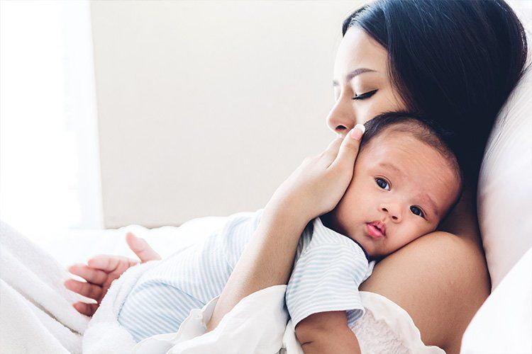 Young mother holding her baby - Dental Studio 4 Kids Lutz Florida