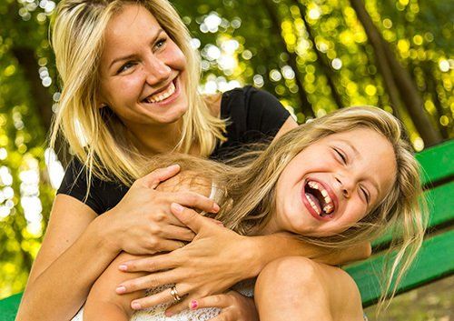 mom and daughter laughing