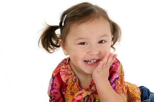 girl holding mouth