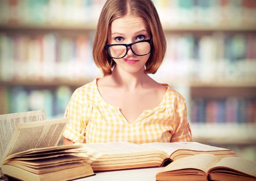 woman with glasses smirking