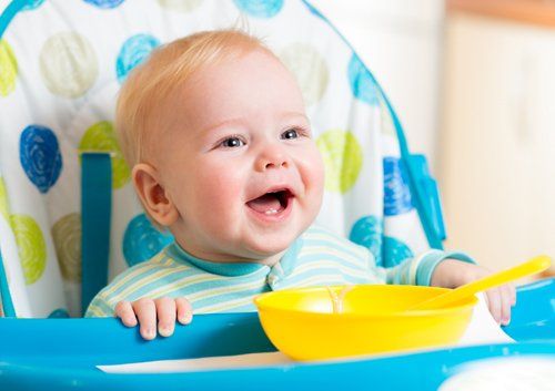 baby in chair smiling