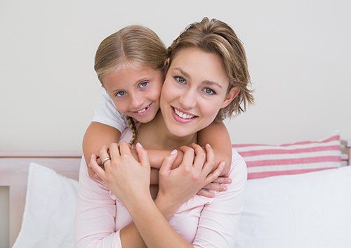 girl hugging mom's neck