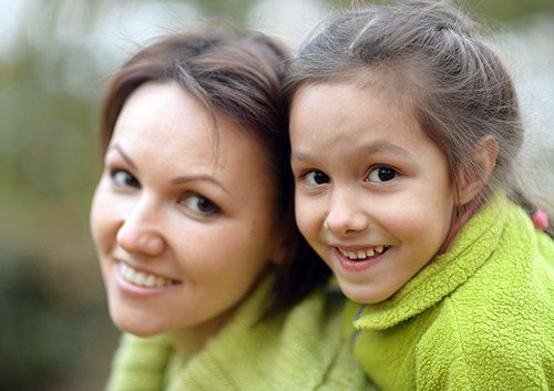 woman and daughter smiling