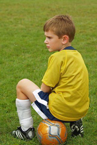 kid sitting on ball