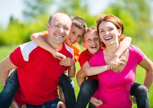 family of four smiling