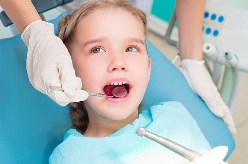 girl getting teeth checked