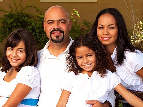 family of four smiling