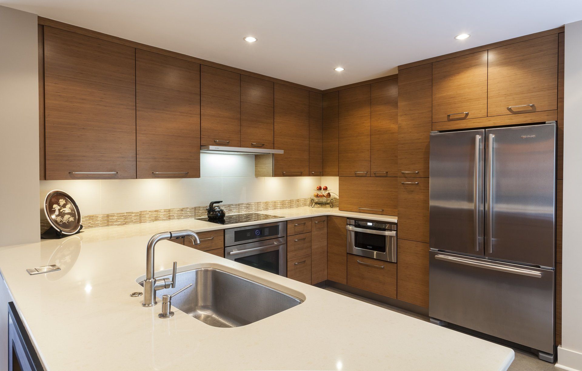 A kitchen with stainless steel appliances and wooden cabinets