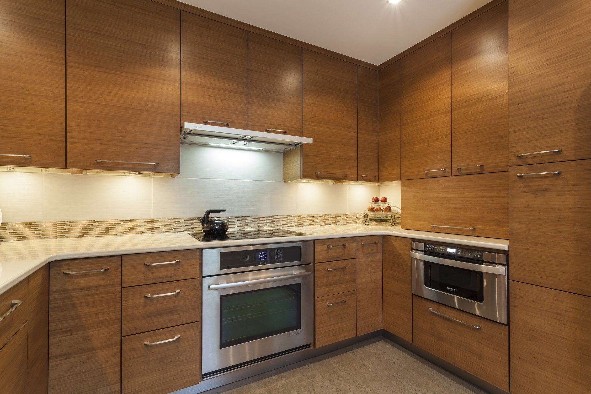 Modern kitchen with wooden cabinets, granite counters, and stainless steel appliances.