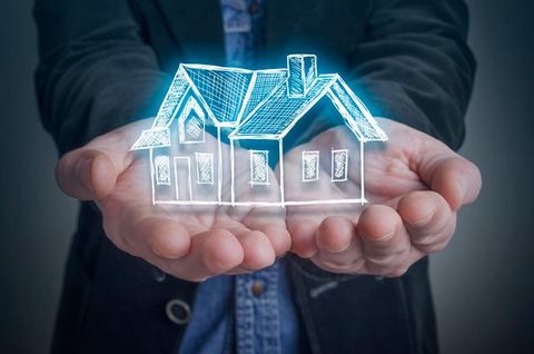 hand holding house