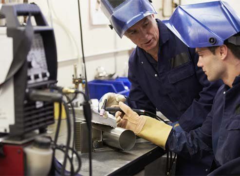 Engineer Teaching Apprentice To Use TIG Welding Machine - Metal Product Manufacturers in Maple Grove, MN Engineer Teaching Apprentice To Use TIG Welding Machine - Metal Product Manufacturers in Maple Grove, MN