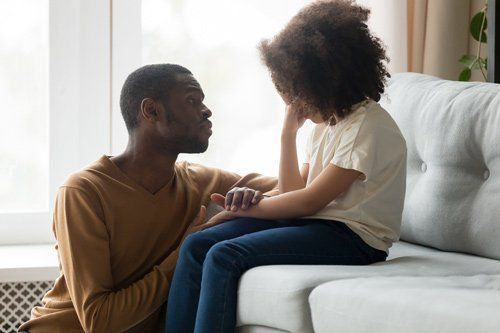 Man Comforting Crying Kid — Placentia, CA — Law Offices of Kennith L. Peterson