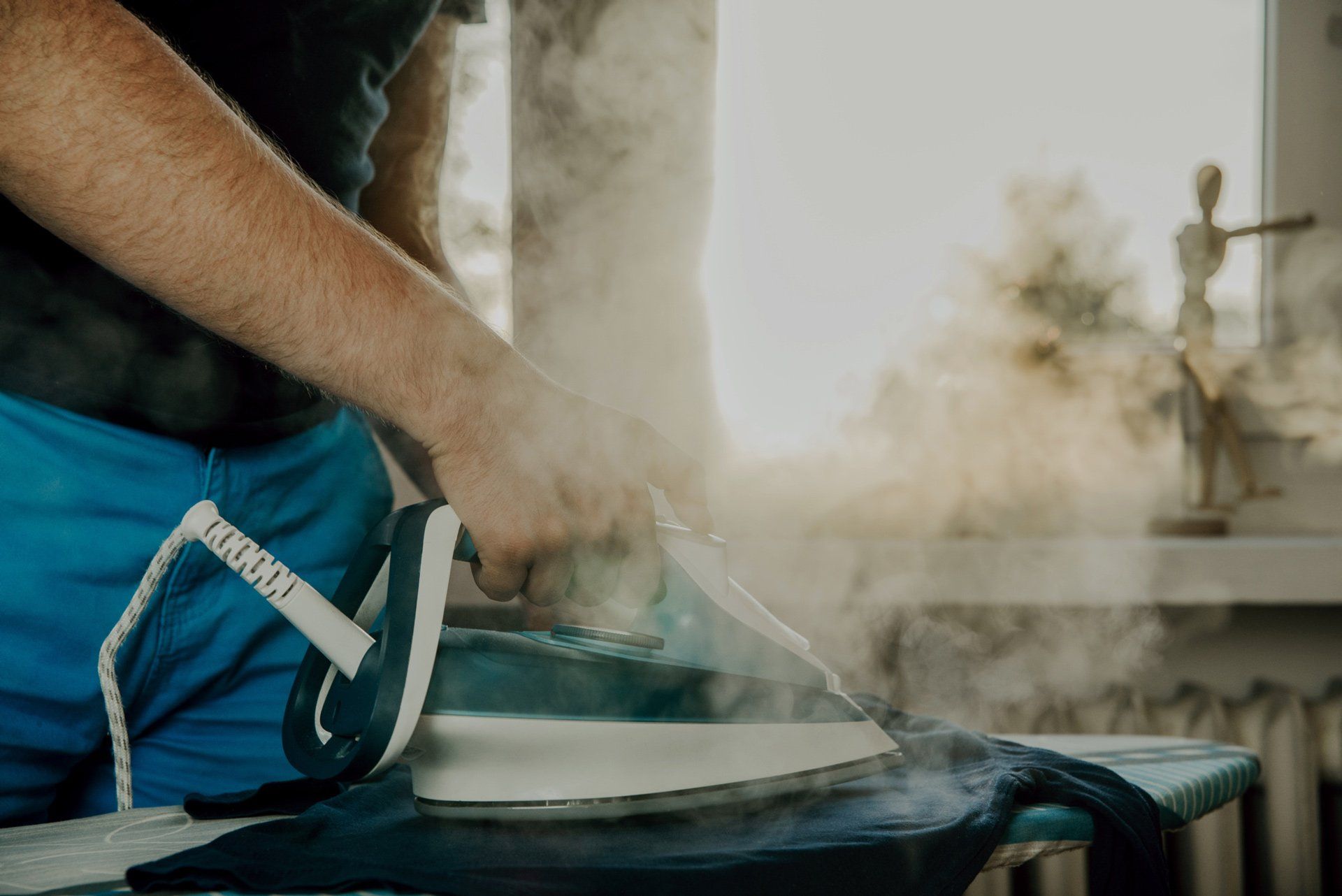 Man Ironing Clothes— Placentia, CA — Law Offices of Kennith L. Peterson