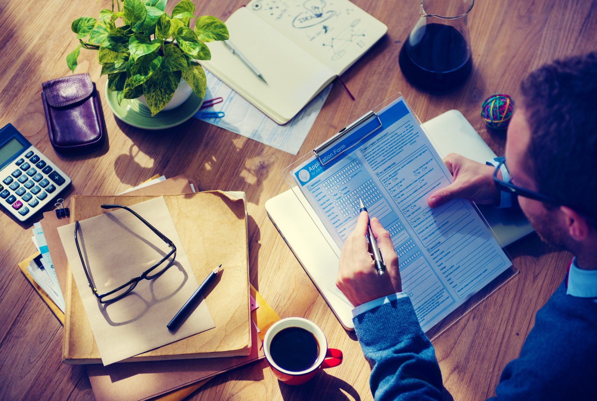 Home and Auto Insurance — Man Writing in Insurance Form in Largo, FL