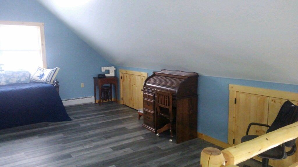 A bedroom with a sewing machine and a desk