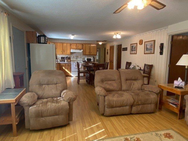 A living room with a couch and two chairs