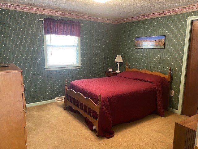A bedroom with a large bed and a window