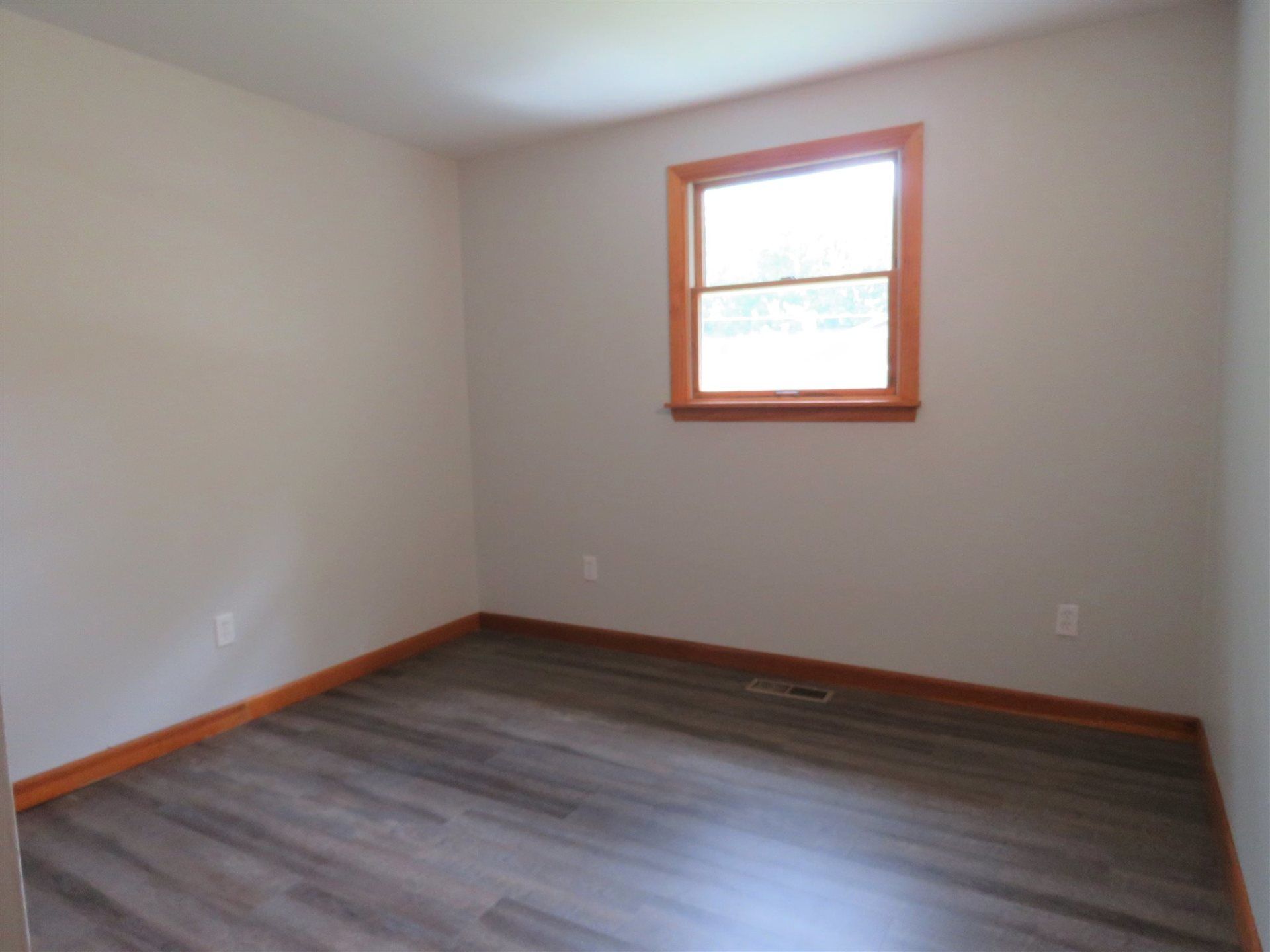 An empty room with a window on the wall
