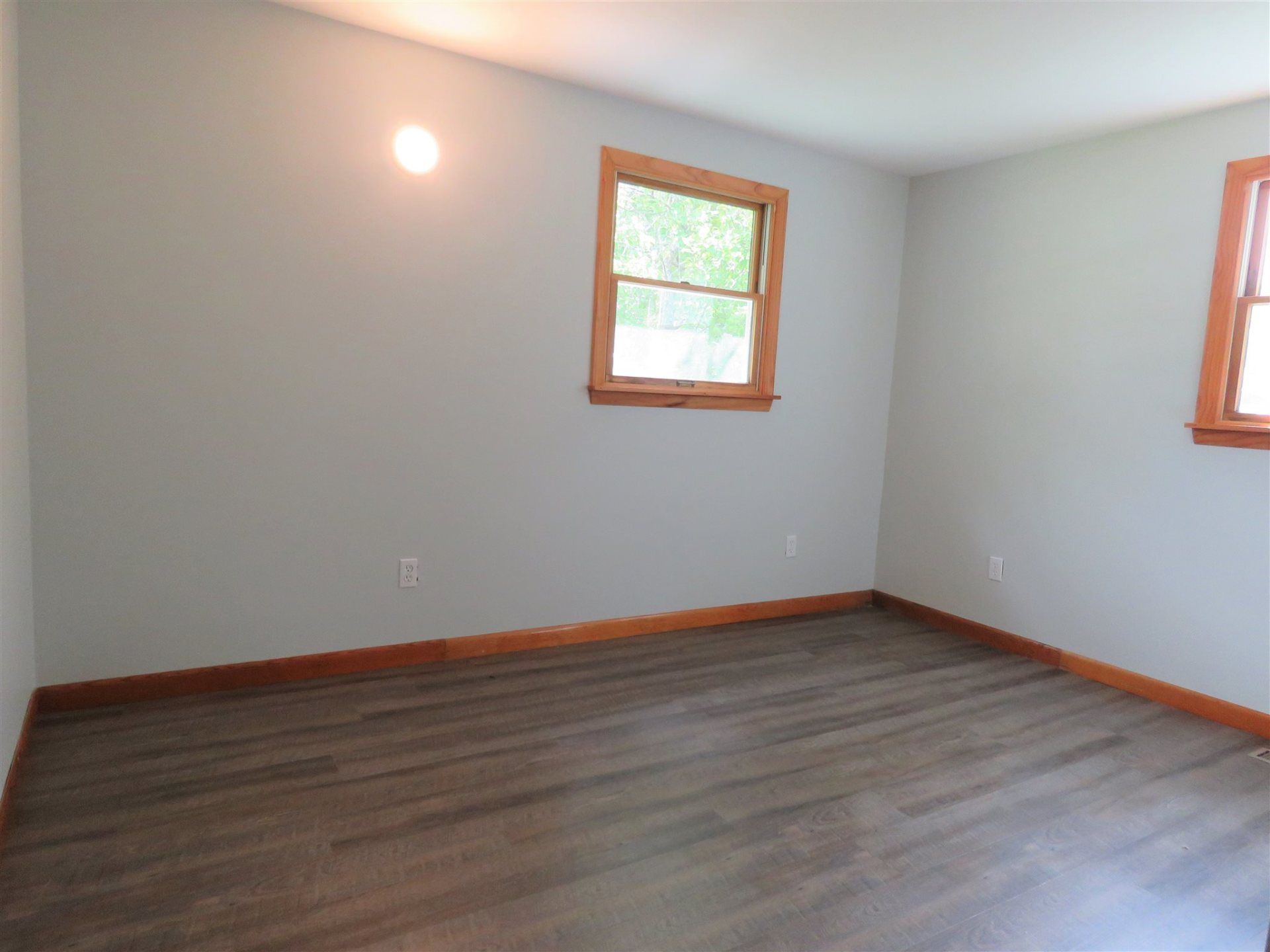 An empty room with a window on the wall