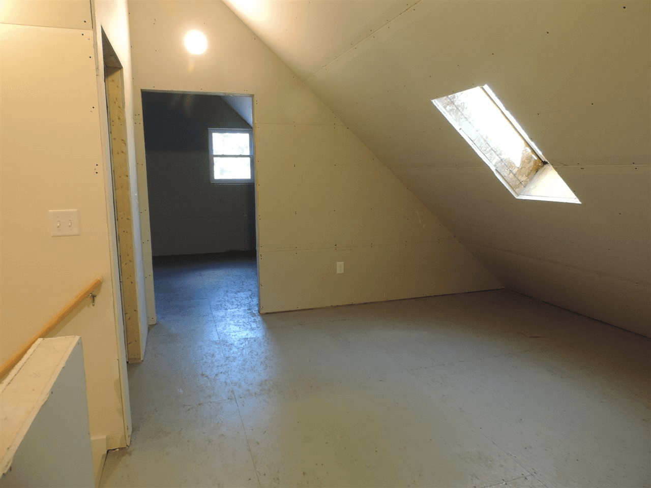 An empty room with a skylight in the ceiling