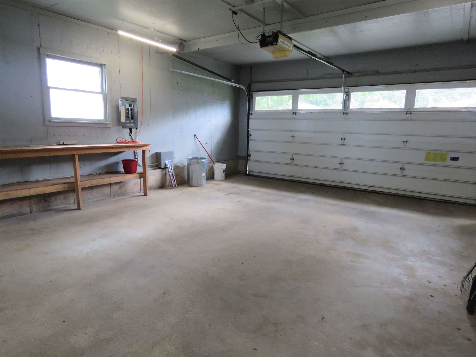 An empty garage with a white garage door