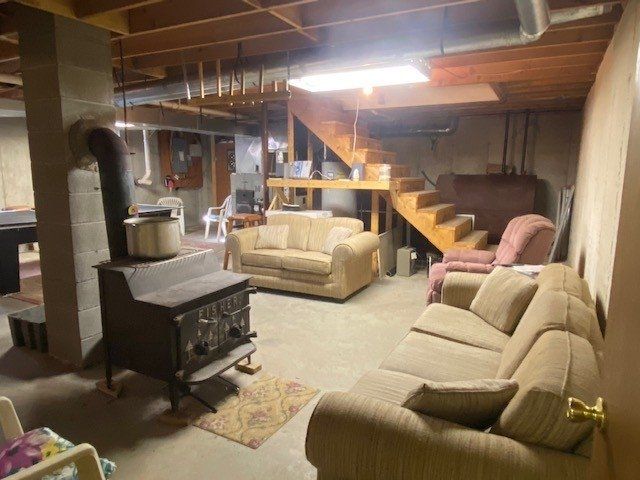 A living room filled with furniture and a wood stove