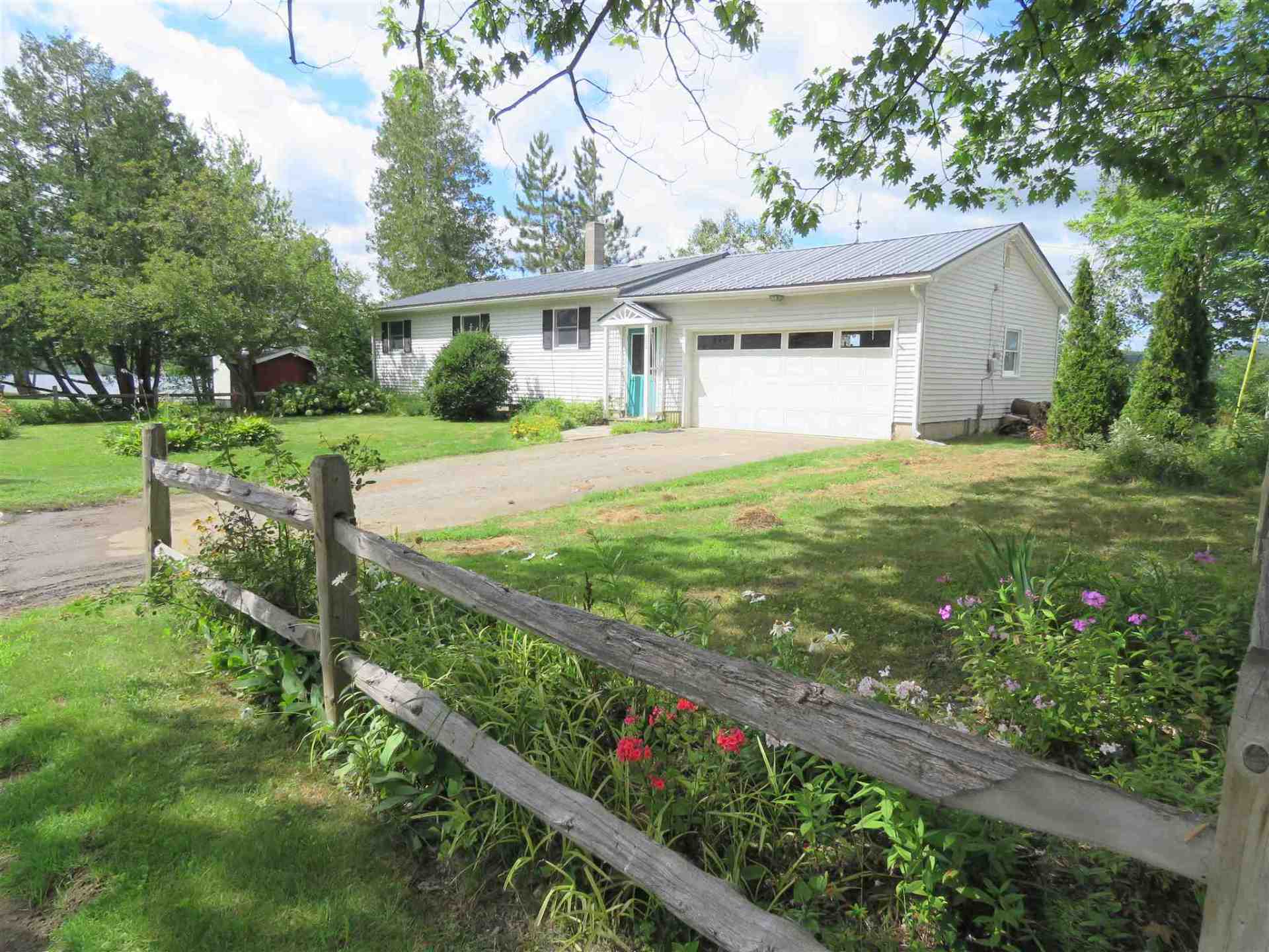 A house with a wooden fence in front of it