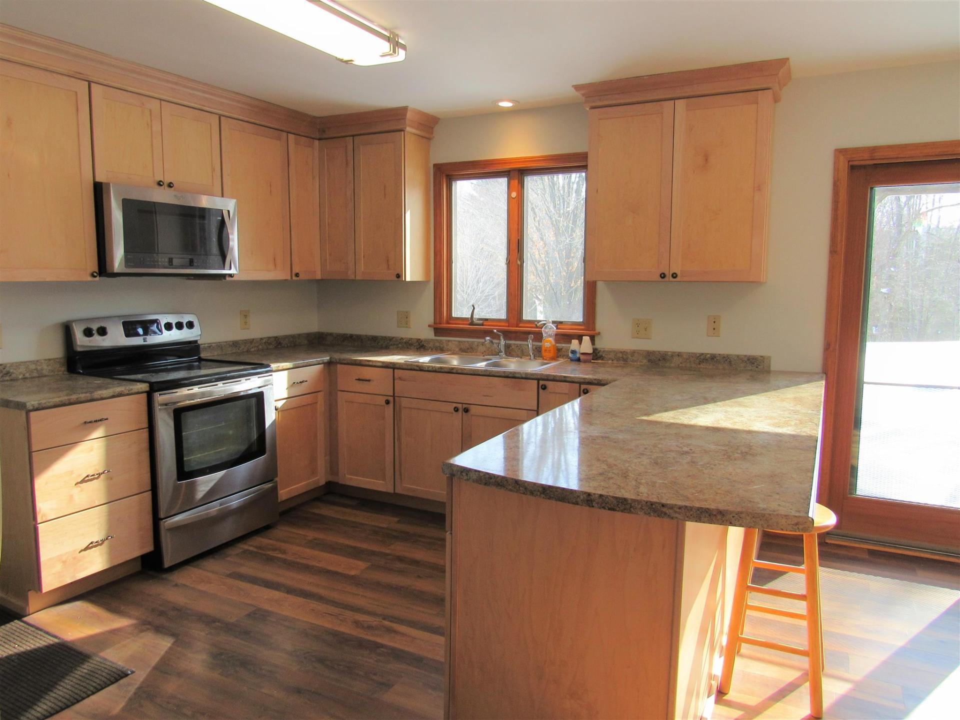 A kitchen with wooden cabinets and granite counter tops