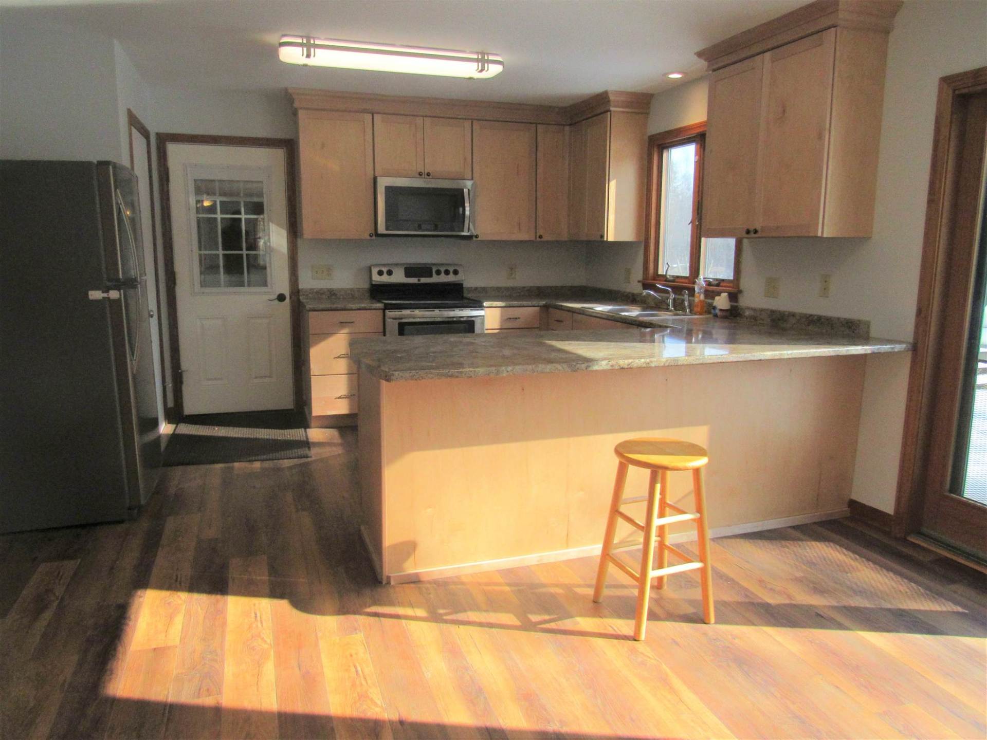 A kitchen with wooden cabinets and granite counter tops