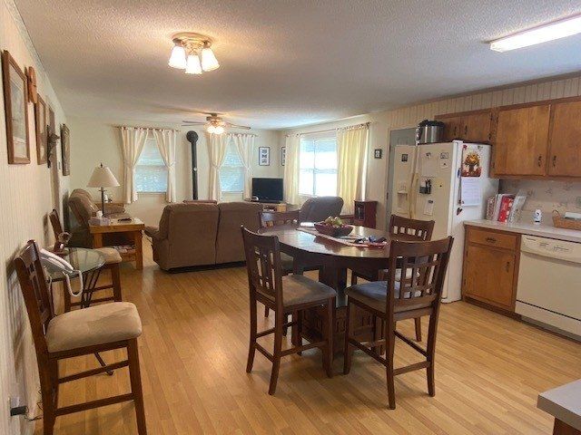 A living room with a table and chairs and a kitchen