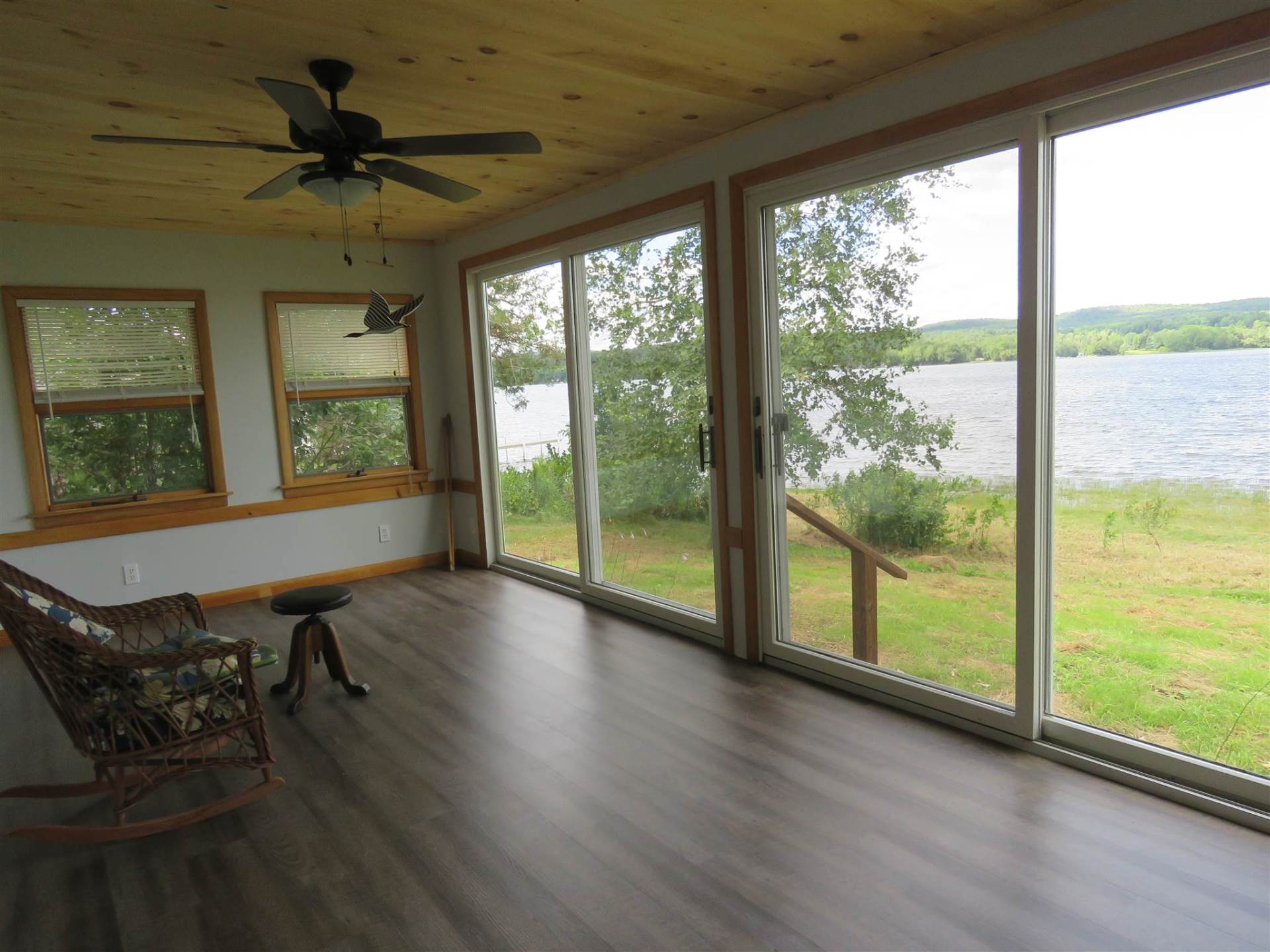 A room with a rocking chair and a ceiling fan