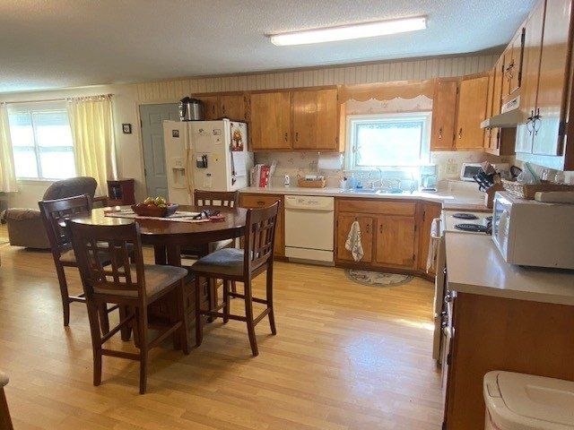A kitchen with a table and chairs in it