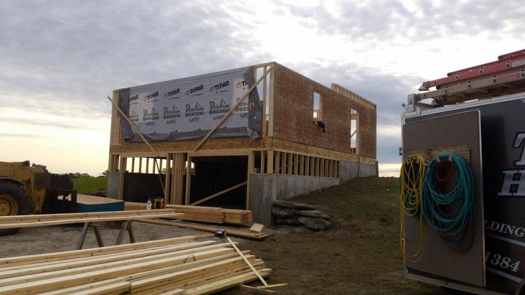 A house is being built in the middle of a field