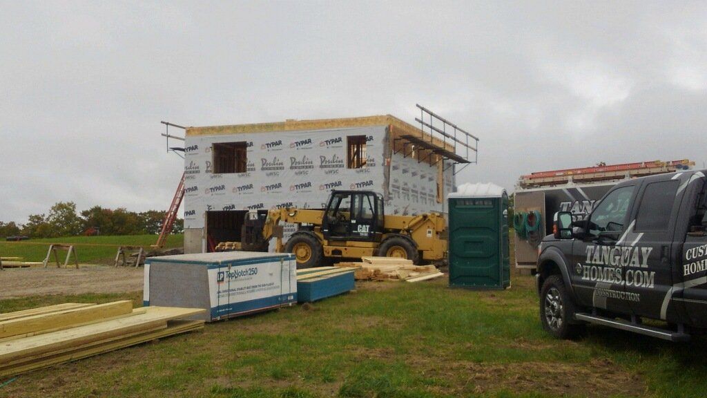 A truck with integrity written on the side is parked in front of a building under construction