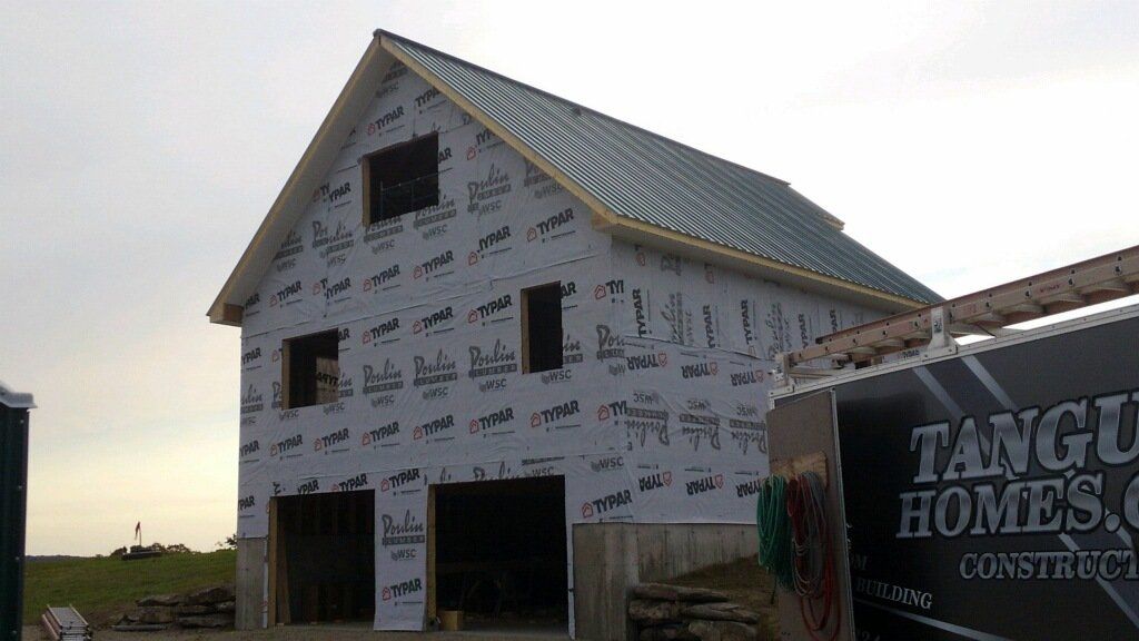 A building under construction with a sign that says tango homes