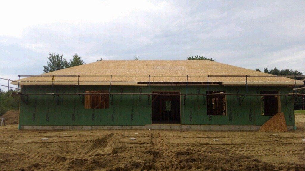 A house is being built in a dirt field