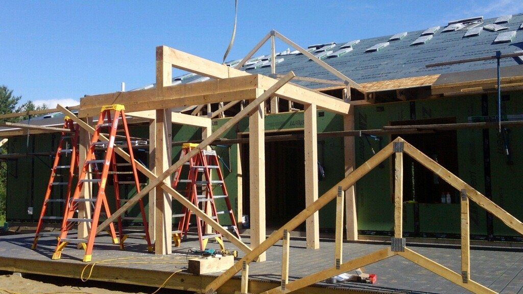 A house that is being built with ladders in front of it
