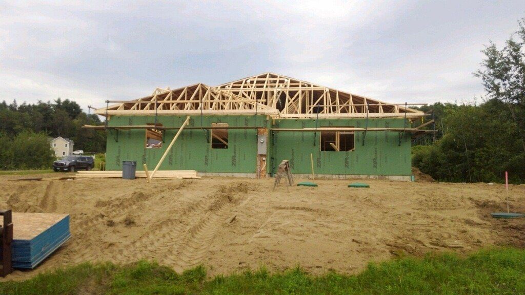 A house is being built in the middle of a dirt field