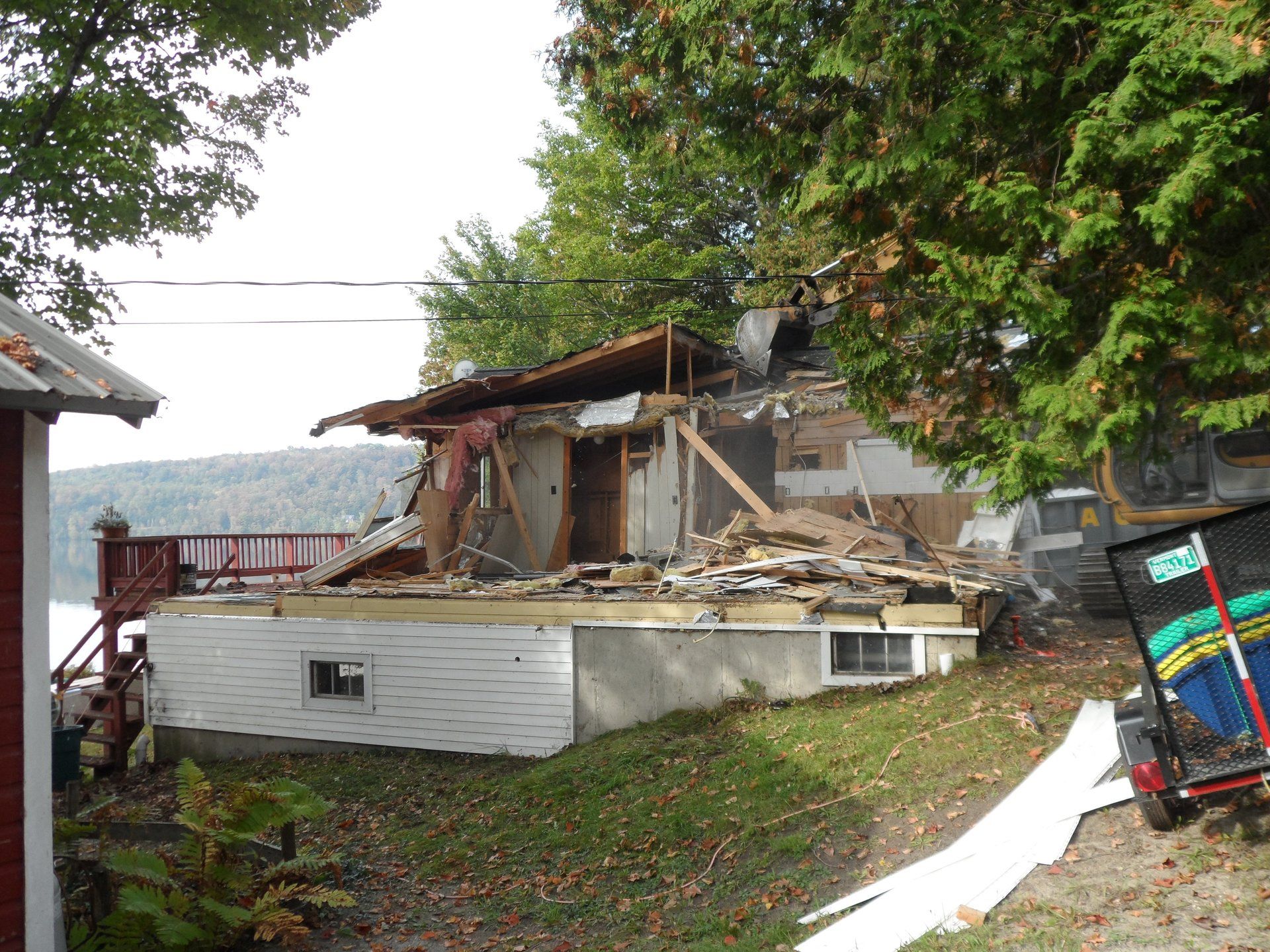 A house that is being demolished with a sign that says ' demolition ' on it