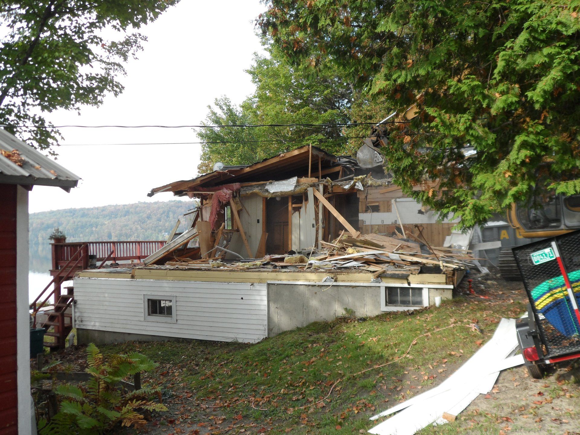 A house is being demolished with a sign that says ' demolition ' on it