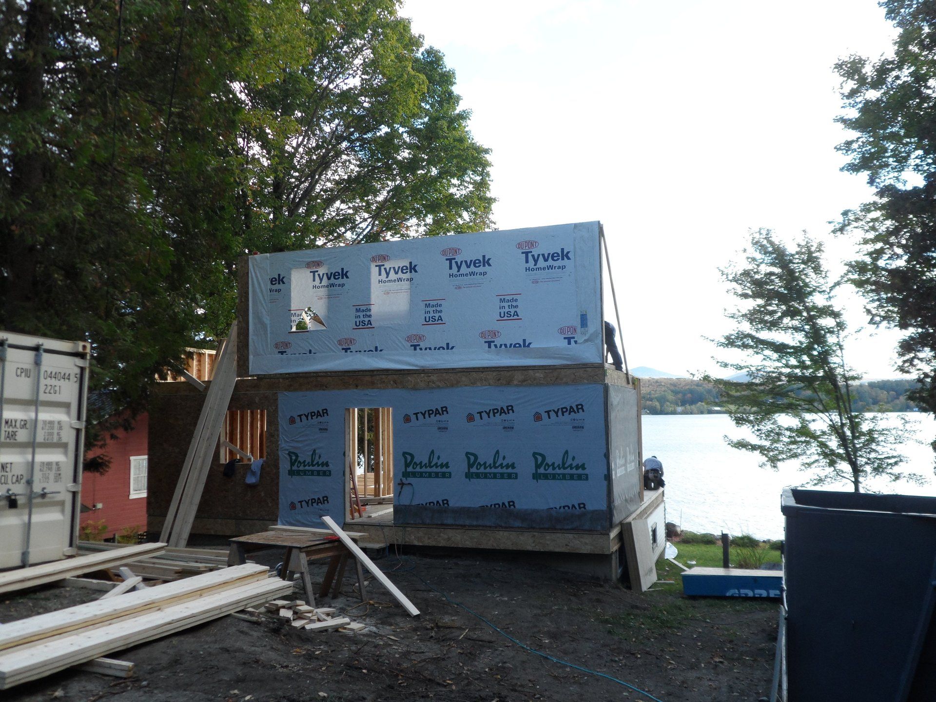 A house is being built on the shore of a lake