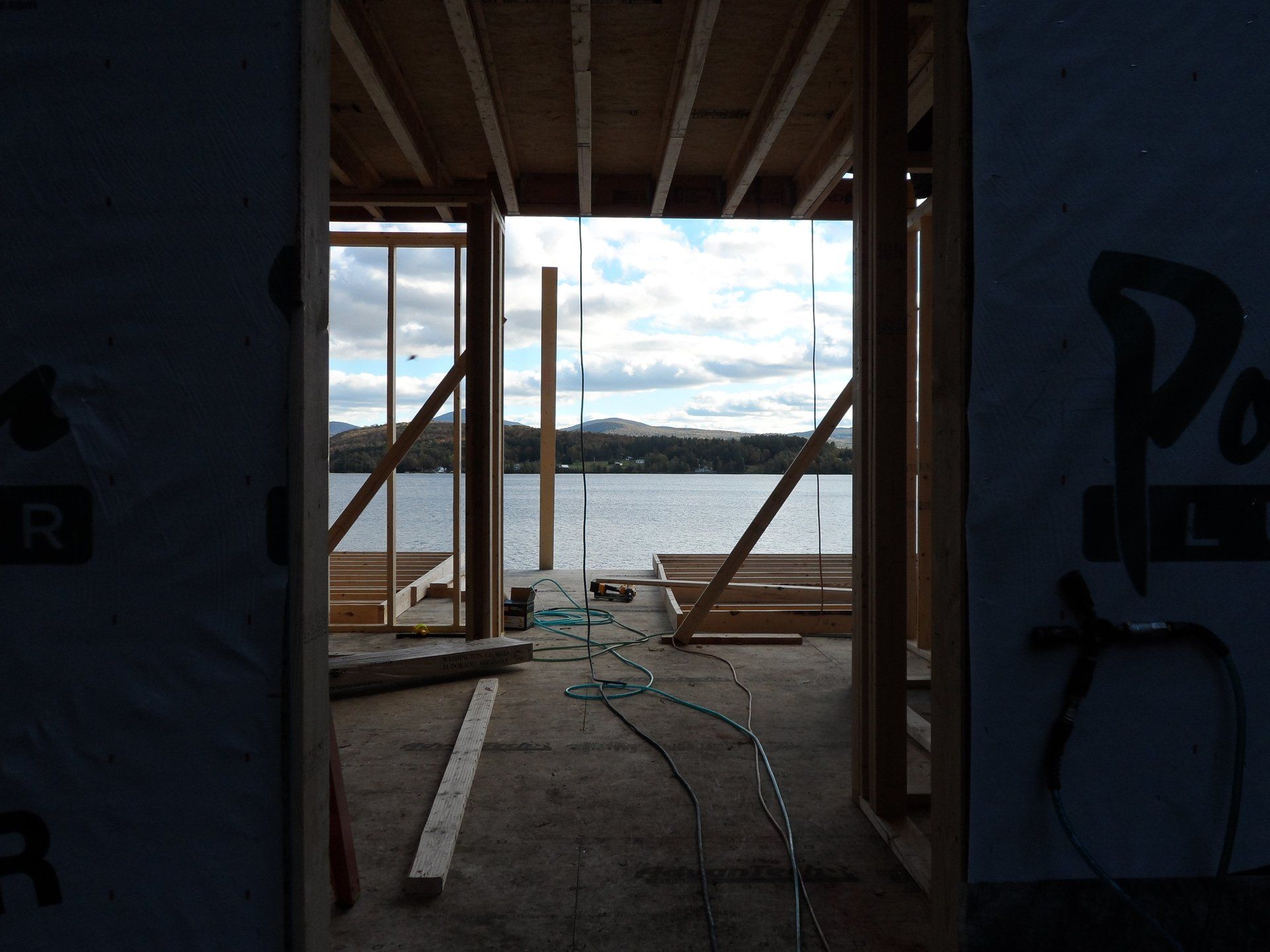 A building under construction with a view of a lake