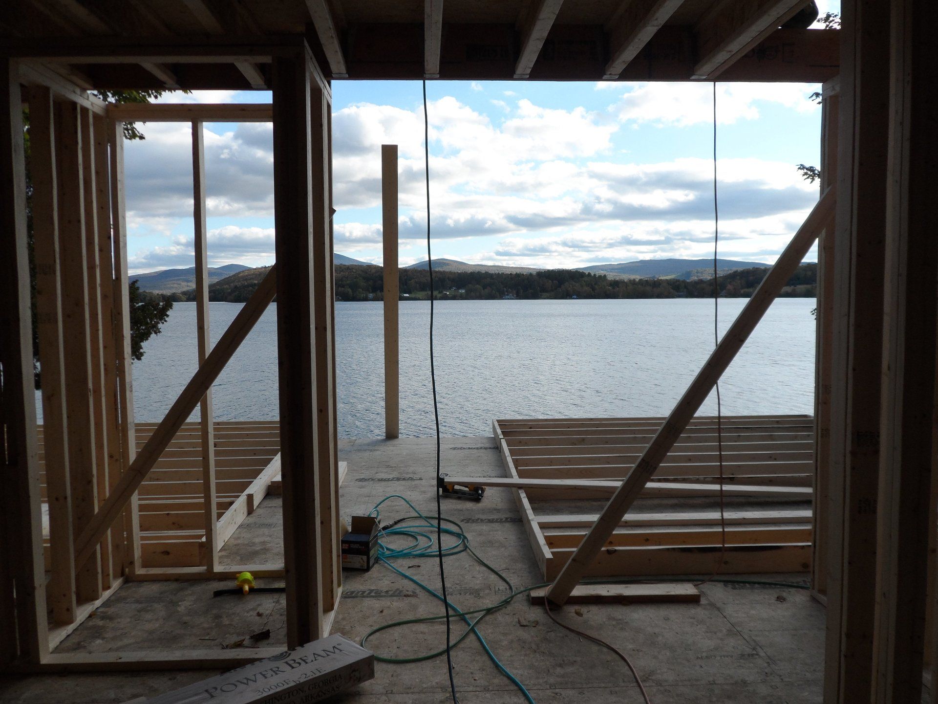 A building under construction with a view of a lake