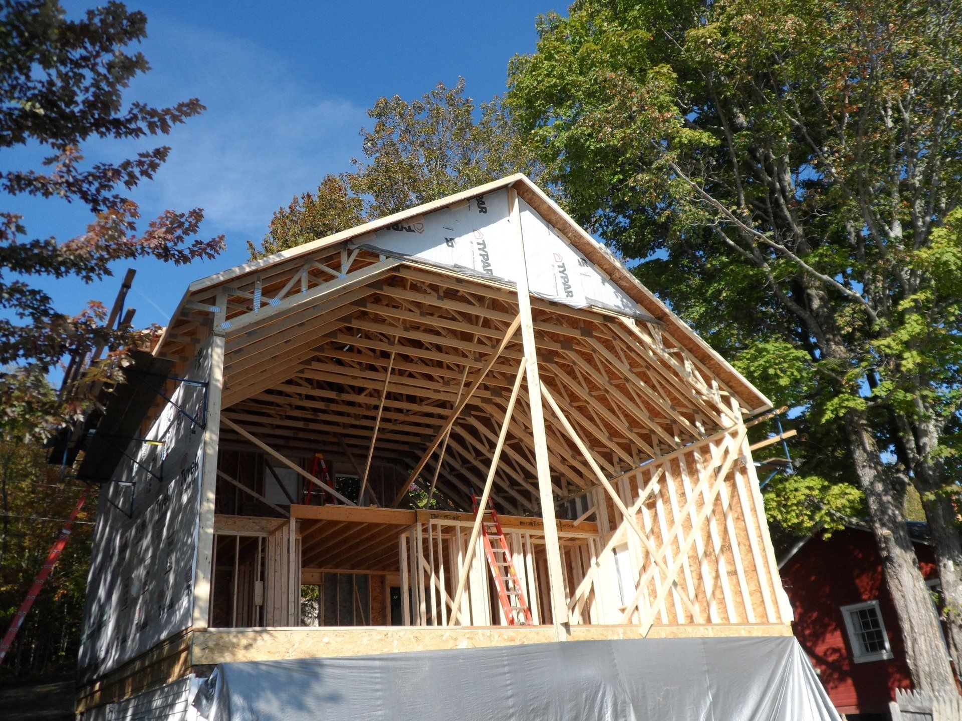 A house that is being built with a large roof