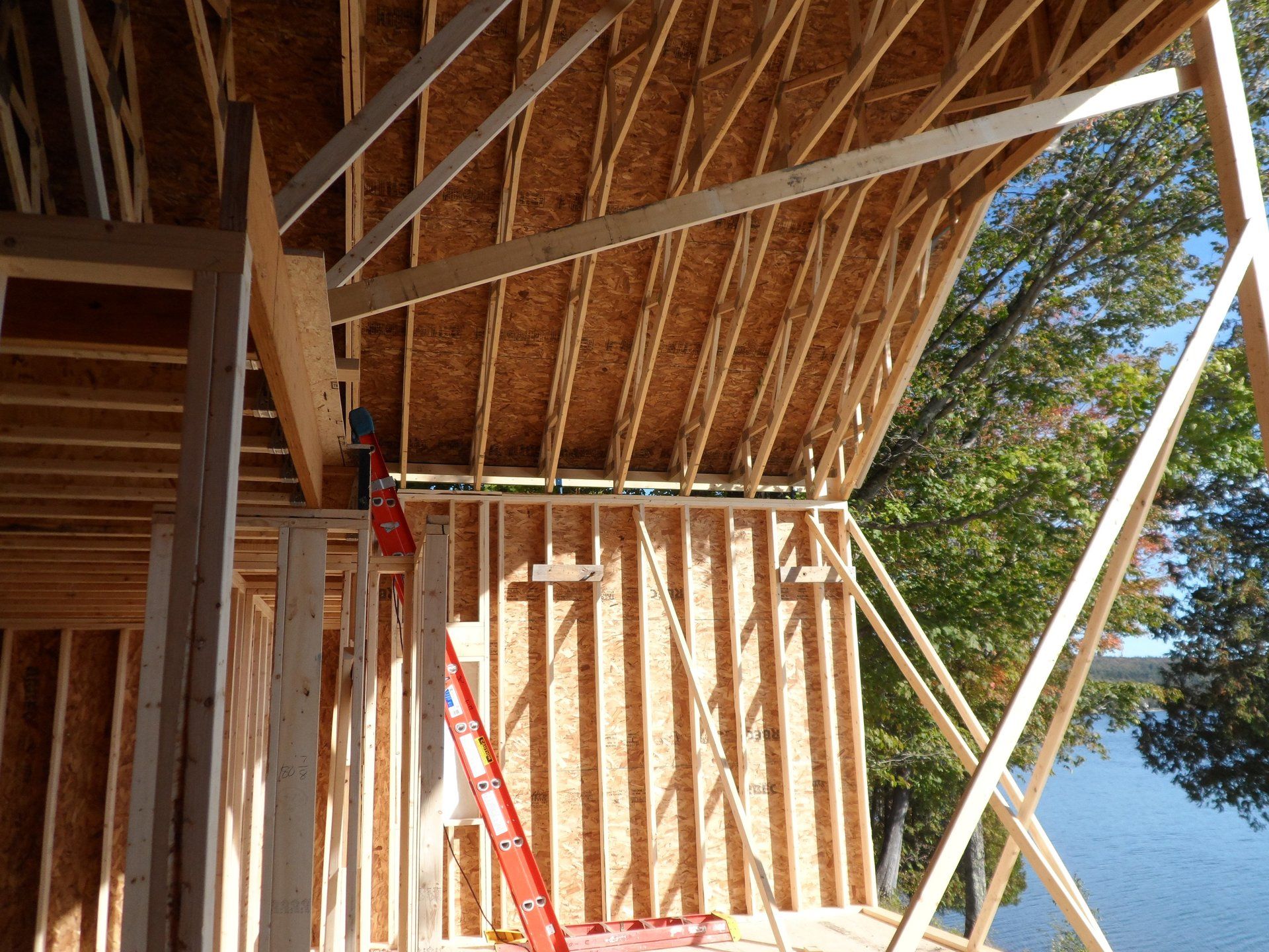 A house is being built with a view of a lake.