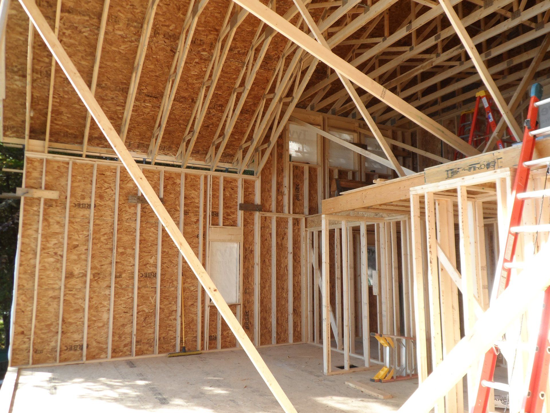 The inside of a house under construction with a ladder in the foreground