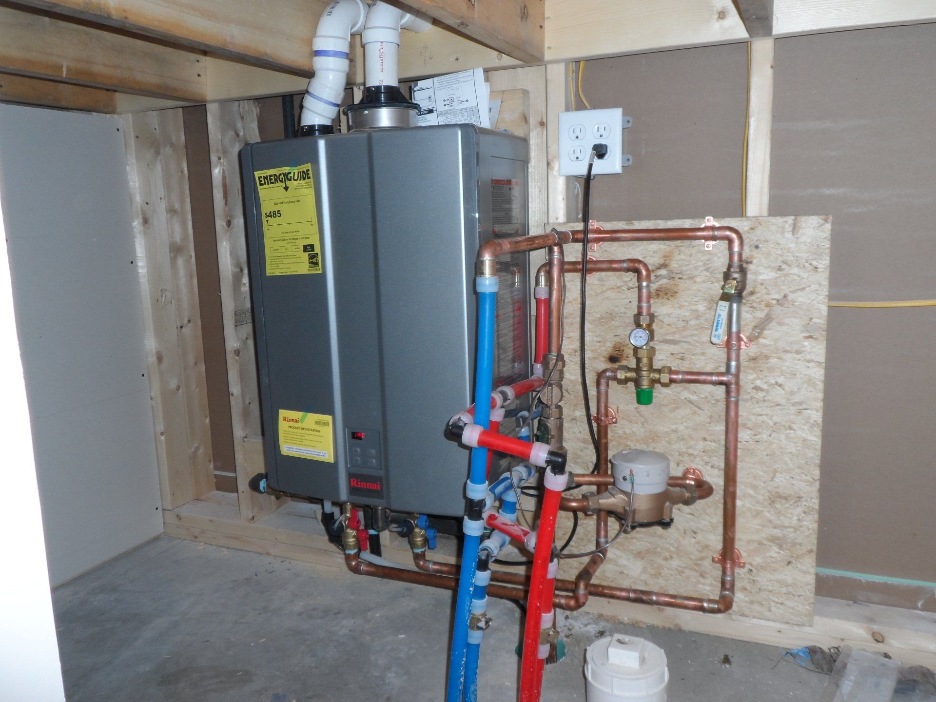 A water heater with a yellow sticker on it