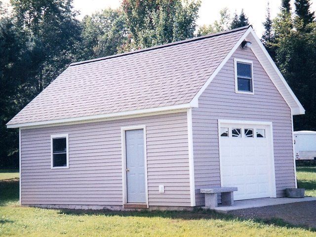 A small house with a white garage door