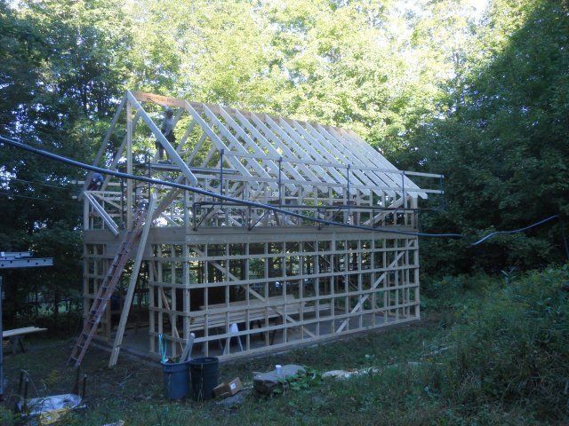A wooden structure is being built in the woods